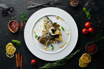 Baked trout on a plate. Dishes, food. Top view. Free space for your text.