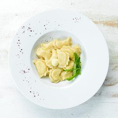 Dumplings with potatoes, butter and sour cream. Ukrainian traditional cuisine. Top view. Free space for your text.