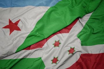 Obraz premium waving colorful flag of burundi and national flag of djibouti.