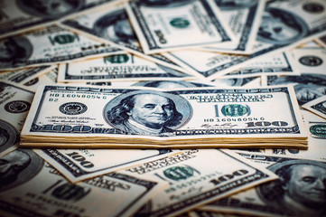 A pile of one hundred US banknotes. Cash of hundred dollar bills, dollar background image.