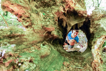 The boy cheerfully studies everything in mountain caves.
