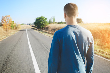 Young man standing on road. Concept of choice