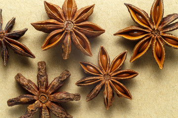 Star anise star on paper rough background top view close-up.