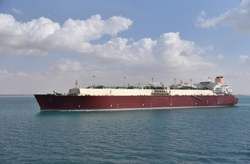Large gas tanker ship transiting Suez Canal on a sunny day. 