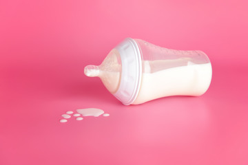 Bottle of milk for baby on color background