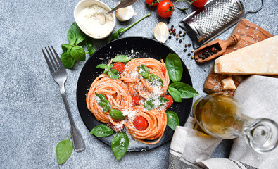 italian pasta spaghetti  with tomato, parmesan cheese and basil.  pasta recipe. selective focus