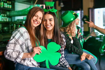 Young women celebrating St. Patrick's Day in pub