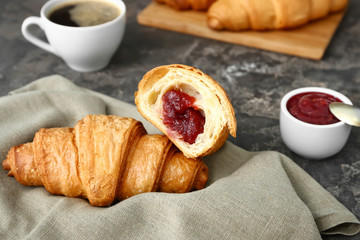 Tasty sweet croissants on grunge background