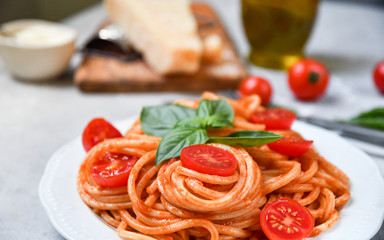 pasta spaghetti with tomatoes and basil.  traditional dish of Italian cuisine. pasta recipe