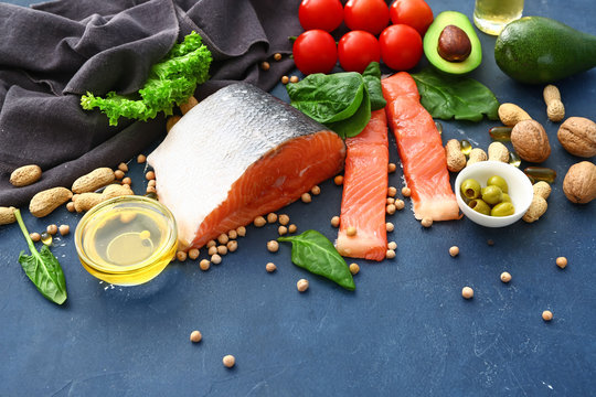 Healthy products rich in omega-3 on color background
