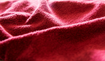 texture of red fabric, selective focus and blurred background.