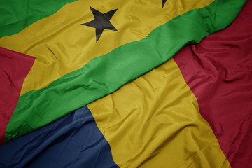 waving colorful flag of chad and national flag of sao tome and principe .