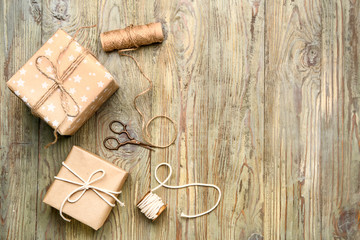 Fototapeta na wymiar Packed gifts on wooden background