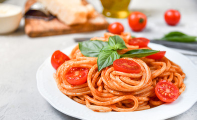 pasta spaghetti with tomatoes and basil.  traditional dish of Italian cuisine. pasta recipe