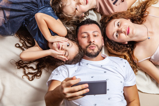 Happy family taking selfie picture with smartphone