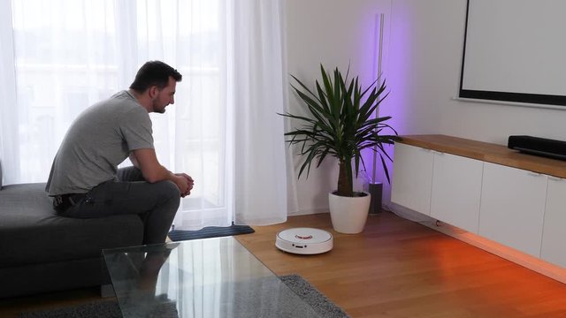 Home owner accessing vacuum cleaner robot via voice command