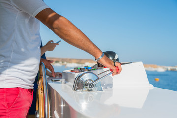 Captain at the helm yacht. Men's hand drives a yacht. concept of sea recreation and tourism