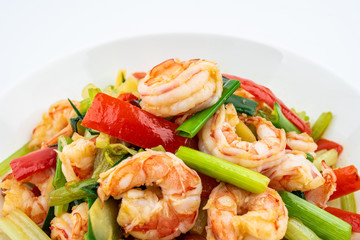 Stir-fried shrimp with celery in a dish on white background
