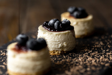 Delicious handmade mini cheesecake with rustic wood background.