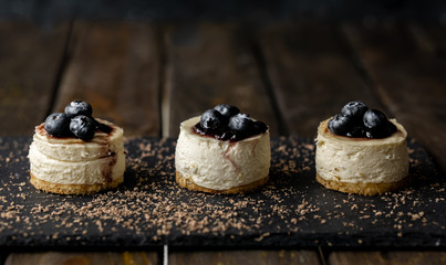 Delicious handmade mini cheesecake with rustic wood background.