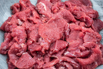 Fresh beef slices on a plate on white background