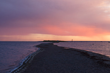 Baltic sea rocky shore at colorful sunset. Long and narrow peninsula
