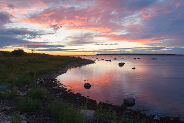 Fototapeta na wymiar Baltic sea rocky shore at colorful sunset.