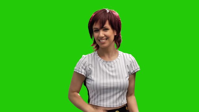 Beautiful cheerful woman adjust short hair on green screen