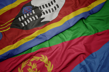 waving colorful flag of eritrea and national flag of swaziland.