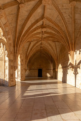 Fototapeta na wymiar The sun entering between the arches of The Jeronimos Monastery in Lisbon, Portugal