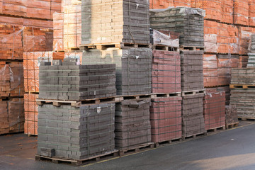 pallets with bricks in the building store. Racks with brick. Masonry, stonework. Several pallets with concrete brick stacked on top of each other in depot. new bricks on pallets