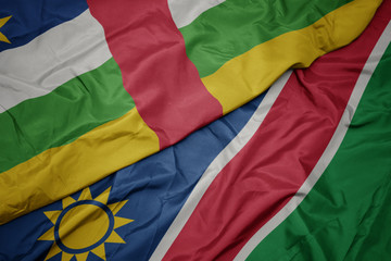 waving colorful flag of namibia and national flag of central african republic.
