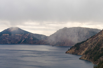 A storm cloud discharging water over Crater Lake