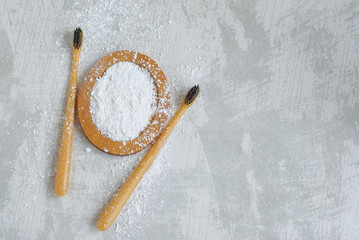 bamboo eco friendly toothbrushes and tooth powder, zero waste tooth cleaning set on concrete...