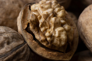 Marco walnut lies between other nuts. The concept of proper nutrition. Beige background