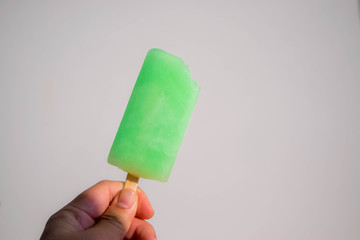 hand holding ice cream on black background