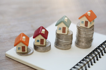 Mini house on stack of coins,Money and house,  Mortgage, Savings money for buy house and loan to...