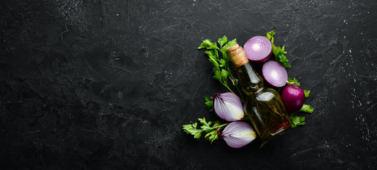 Onion, oil and parsley on old background. Top view. Free copy space.