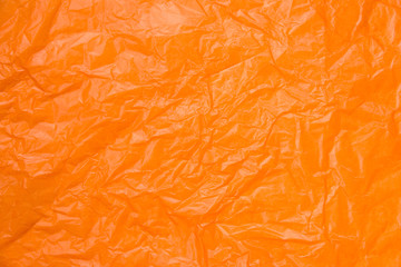 Close up wrinkled orange paper is beautiful. selective focus with blurred foreground and background.