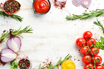 White wooden background of cooking. Spices and vegetables. Top view. Free space for your text.