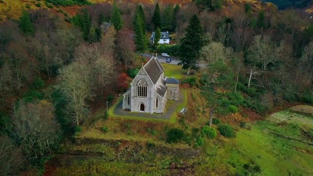 Flying towards back of a church in the Highlands of Scotland