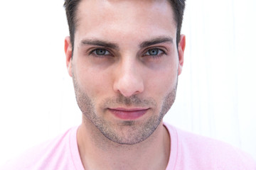 Obraz premium Front portrait of handsome young man staring by white background