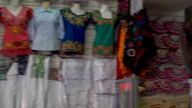 Camera panning to the right showing indigenous Mexican clothing to the Yucatan in Merida, Mexico.
