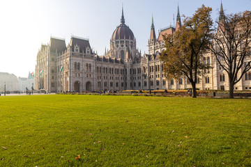 Fototapeta na wymiar Hungarian Parliament famous building and green lawn on a sunny day, Budapest city