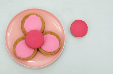 Traditional Dutch pink glazed cakes on a plate.