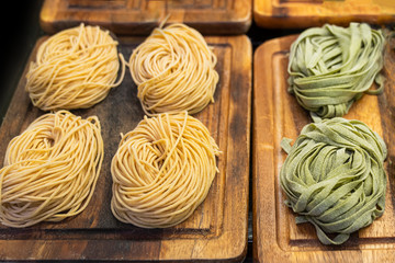 Tagliatelle the store. Italian raw pasta. Delicious traditional dish semi finished product in a cookery or supermarket close up in a refrigerated display case