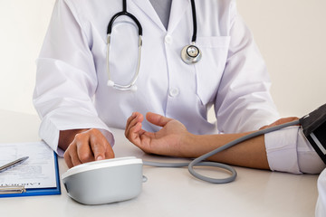 The doctor checks the blood pressure, the patients have an initial health check and talked about...