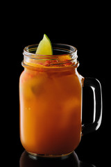 Mug with sea buckthorn and lemon cocktail isolated on black background