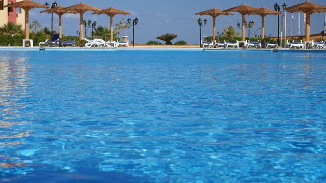 Clouse up Shot of Blue Water in Swimming Pool . Tropical Resort in Egypt, Marsa Alam.