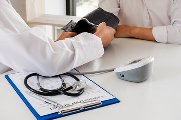The doctor checks the blood pressure, the patients have an initial health check and talked about...